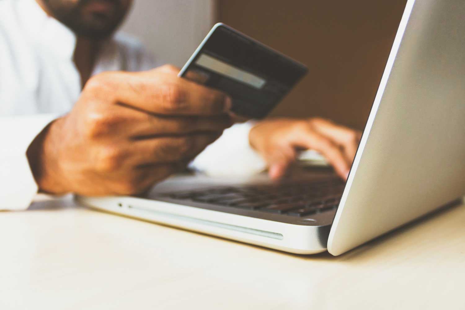 a person holding a credit card on hand